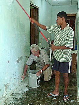 Malcolm prepares the walls for new paint.